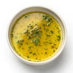 The Ultimate Guide to Basic Vinaigrette Recipes 3 Glass jar of homemade basic vinaigrette on a wooden table with salad ingredients in the background